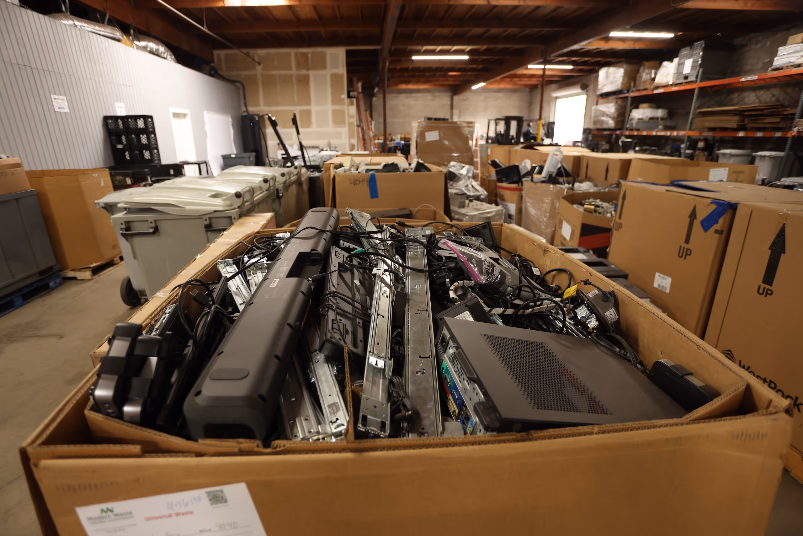 Electronics staged in warehouse storage for processing